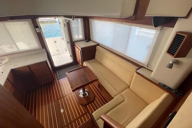  Yacht Photos Pics Interior of 2018 American Tug 365 with wood flooring and beige seating.