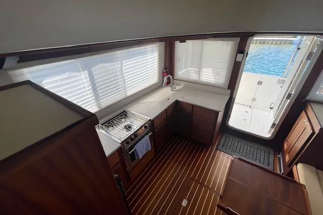 Yacht Photos Pics Interior of 2018 American Tug 365, featuring a compact kitchen with wood flooring.