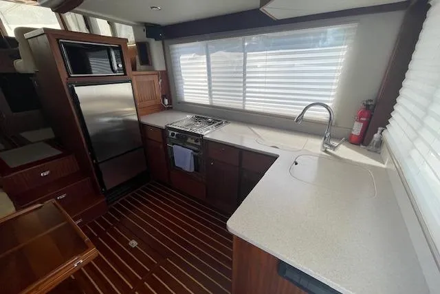  Yacht Photos Pics Modern kitchen in 2018 American Tug 365 with stainless appliances and wood flooring.