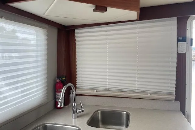  Yacht Photos Pics Interior of 2018 American Tug 365 with dual sinks and window blinds.