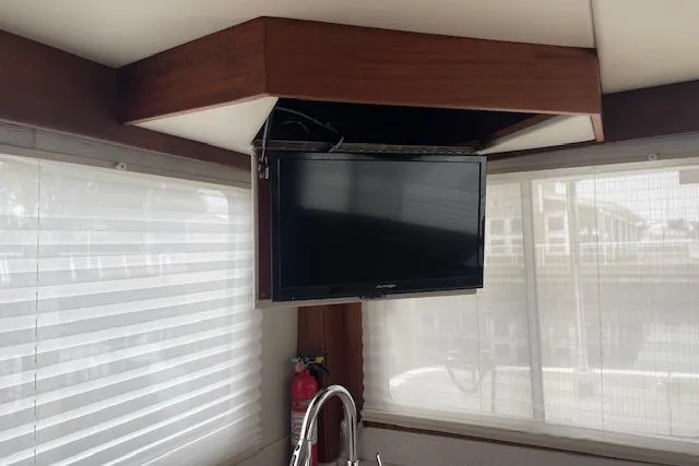  Yacht Photos Pics Interior of 2018 American Tug 365 with mounted TV and window blinds.