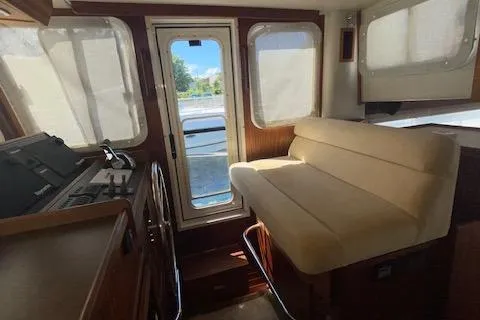  Yacht Photos Pics Interior of 2018 American Tug 365 with beige seating and large windows.