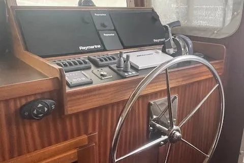  Yacht Photos Pics 2018 American Tug 365 helm with Raymarine navigation and wooden steering wheel.