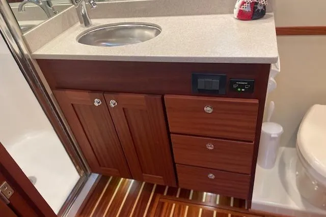  Yacht Photos Pics 2018 American Tug 365 bathroom with wooden cabinetry and modern fixtures.