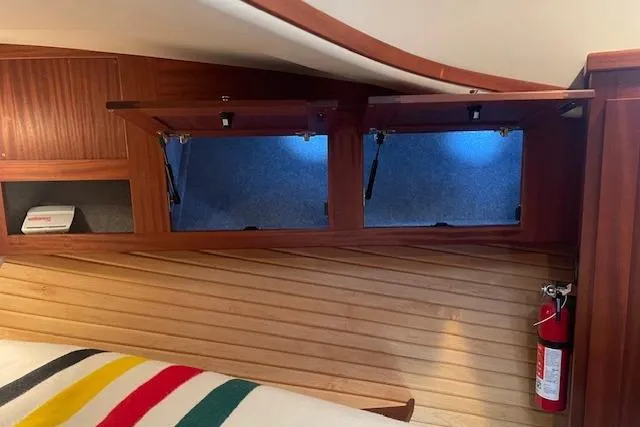  Yacht Photos Pics Interior of 2018 American Tug 365 with wooden cabinets and fire extinguisher.