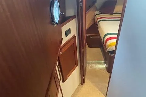  Yacht Photos Pics Interior of 2018 American Tug 365, featuring cozy cabin with striped bedding.