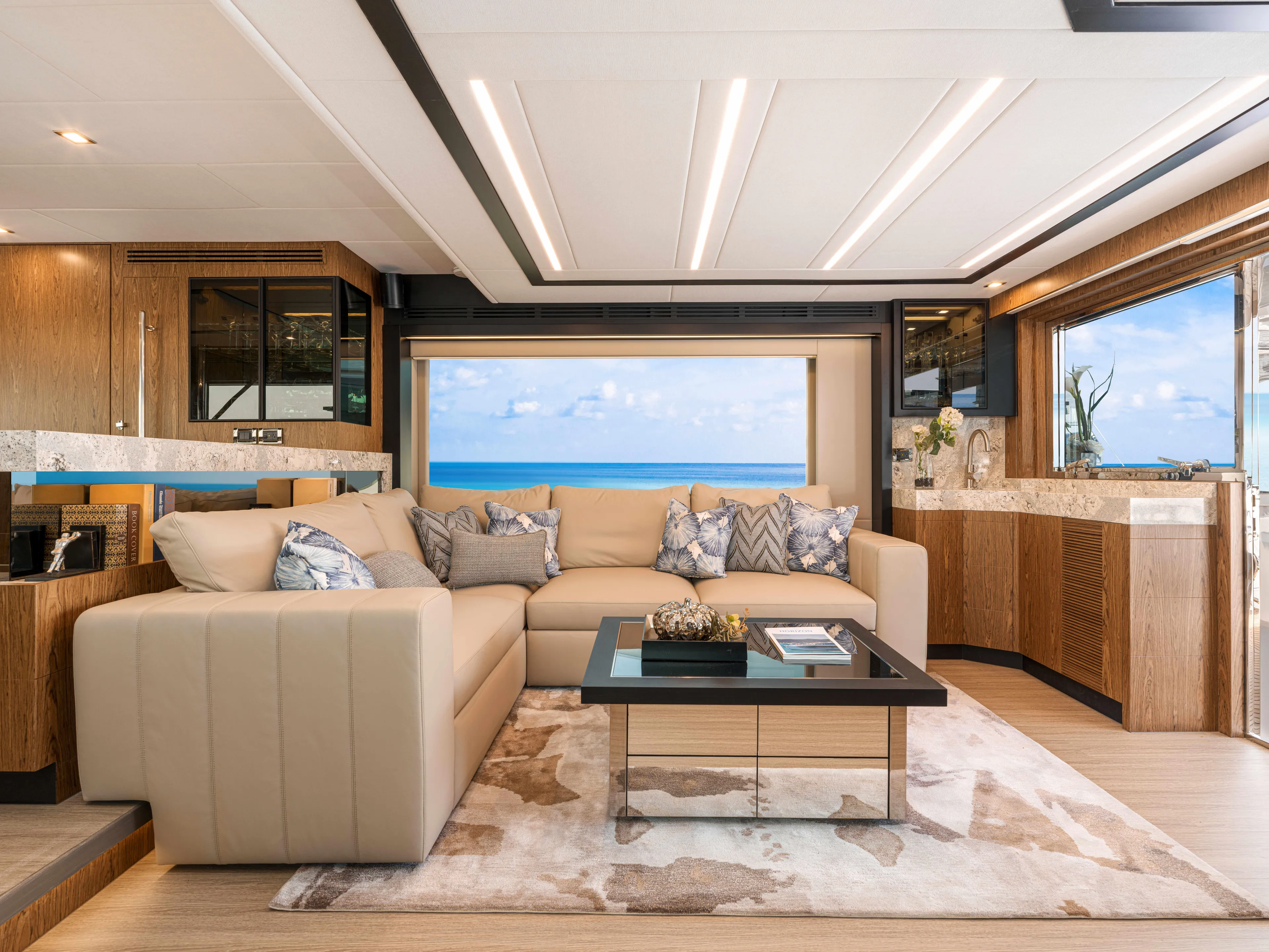 V68-612 / Now Available Yacht Photos Pics Luxurious Horizon V68 yacht interior with ocean view, featuring elegant beige sofa and modern decor.