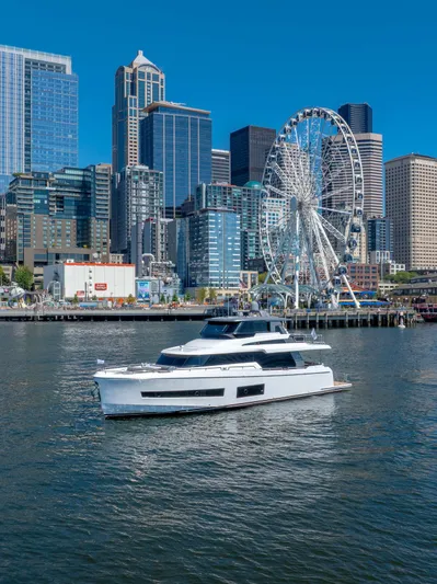 V68-612 / Now Available Yacht Photos Pics 2025 Horizon V68 yacht cruising near city skyline and Ferris wheel.
