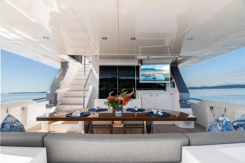 V68-612 / Now Available Yacht Photos Pics Luxurious Horizon V68 yacht deck with dining area, TV, and ocean view, 2025 model.