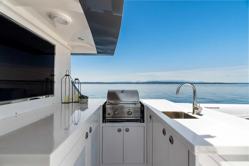 V68-612 / Now Available Yacht Photos Pics Outdoor kitchen on Horizon V68 yacht, featuring grill and sink, with ocean view.