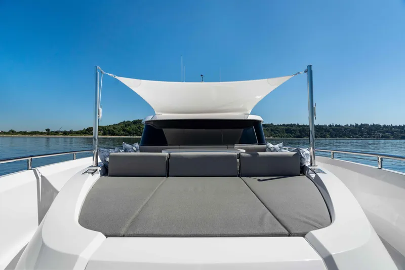 V68-612 / Now Available Yacht Photos Pics Luxurious Horizon V68 yacht deck with sunshade, 2025 model, on calm water under clear blue sky.