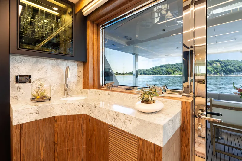 V68-612 / Now Available Yacht Photos Pics Luxurious Horizon V68 yacht interior with marble countertops and scenic water view.
