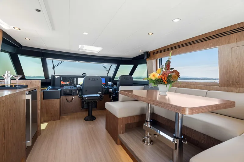 V68-612 / Now Available Yacht Photos Pics Luxurious interior of 2025 Horizon V68 yacht with modern helm and elegant dining area.