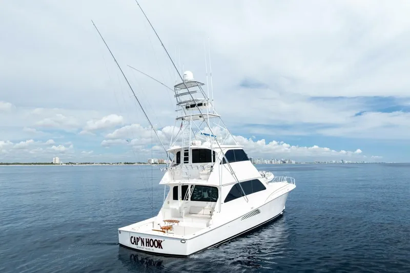 Cap'n Hook Yacht Photos Pics 2006 Viking 68 Enclosed Bridge yacht on calm ocean with city skyline.