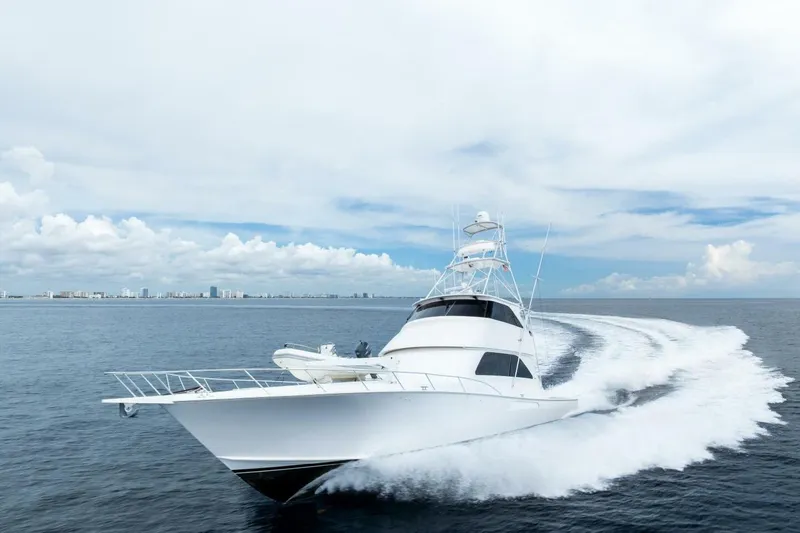 Cap'n Hook Yacht Photos Pics 2006 Viking 68 Enclosed Bridge yacht cruising on open water under a cloudy sky.