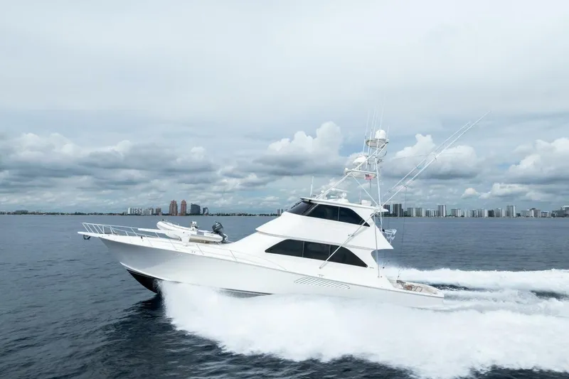 Cap'n Hook Yacht Photos Pics 2006 Viking 68 Enclosed Bridge yacht cruising on open water, city skyline in background.
