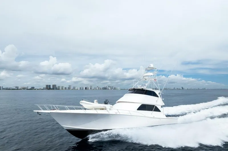 Cap'n Hook Yacht Photos Pics 2006 Viking 68 Enclosed Bridge yacht cruising on open water, city skyline in background.