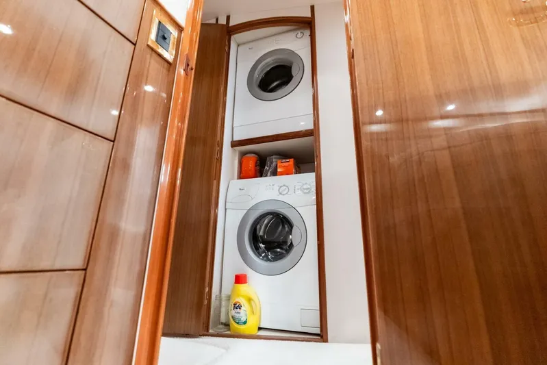 Cap'n Hook Yacht Photos Pics Laundry area in 2006 Viking 68 Enclosed Bridge yacht with stacked washer and dryer.