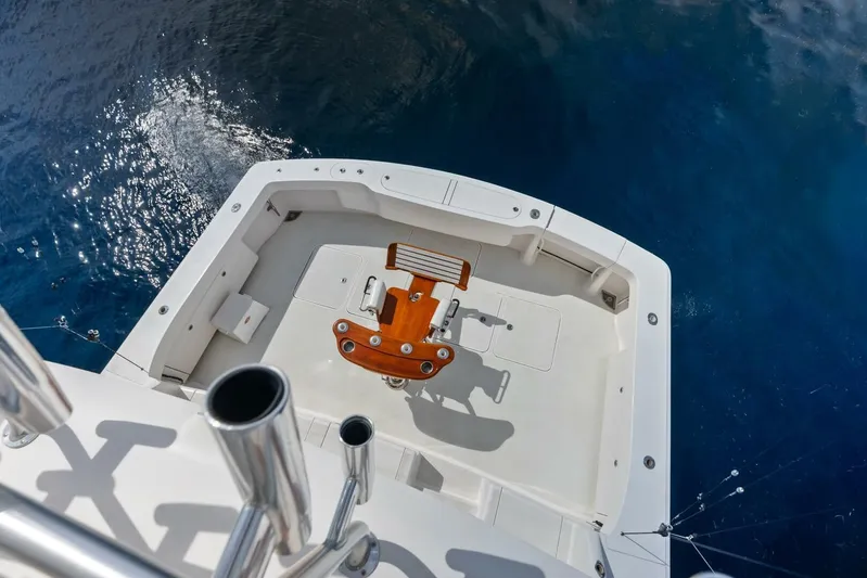 Cap'n Hook Yacht Photos Pics 2006 Viking 68 Enclosed Bridge yacht deck with fishing chair, overlooking blue ocean.