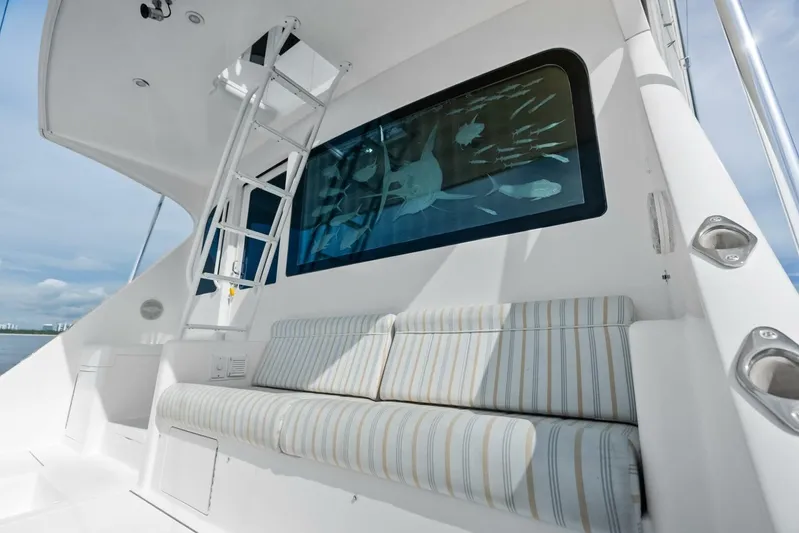 Cap'n Hook Yacht Photos Pics 2006 Viking 68 Enclosed Bridge yacht with striped seating and ladder, featuring ocean-themed window art.