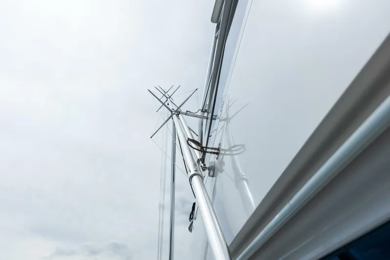 Cap'n Hook Yacht Photos Pics Antenna and rigging on 2006 Viking 68 Enclosed Bridge yacht against cloudy sky.