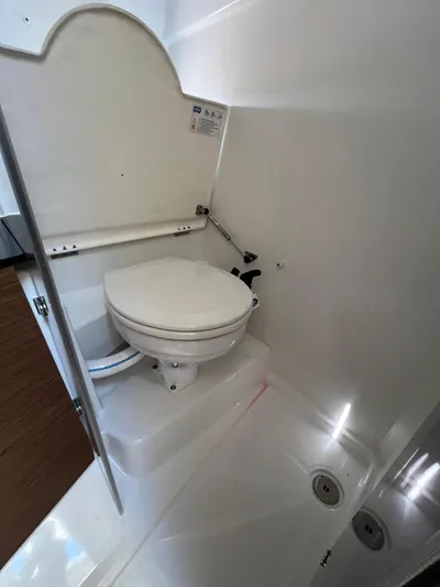  Yacht Photos Pics 2019 Jeanneau Leader 9.0 WA boat bathroom with toilet and shower area.