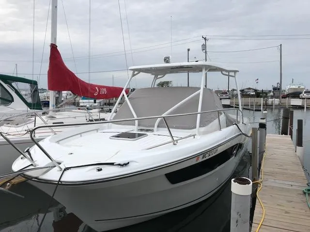  Yacht Photos Pics 2019 Jeanneau Leader 9.0 WA boat docked at a marina, featuring sleek design and canopy.