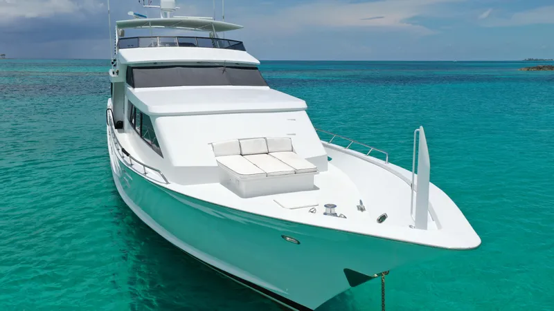 Island Time Yacht Photos Pics 1991 Broward Motor Yacht anchored in clear turquoise waters.