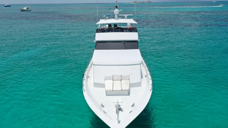 Island Time Yacht Photos Pics 1991 Broward Motor Yacht cruising on clear turquoise waters.