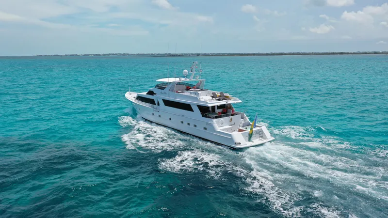 Island Time Yacht Photos Pics 1991 Broward Motor Yacht cruising on clear blue ocean waters.