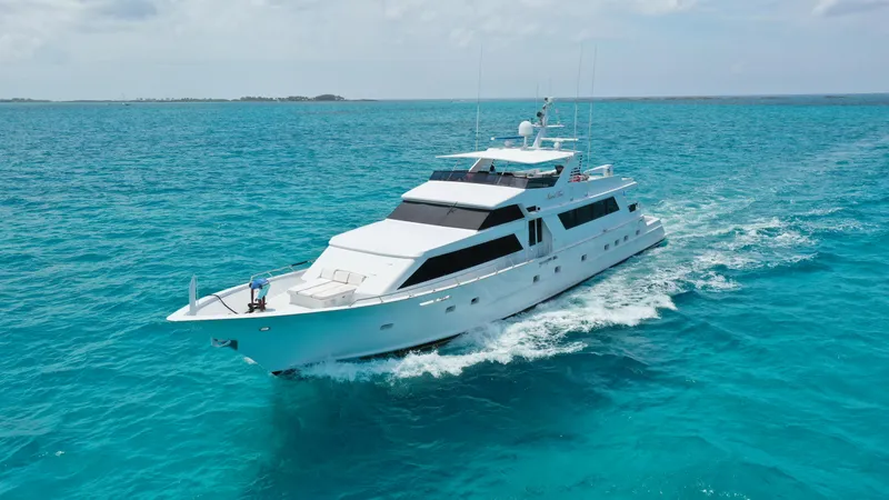 Island Time Yacht Photos Pics 1991 Broward Motor Yacht cruising on clear blue ocean waters.