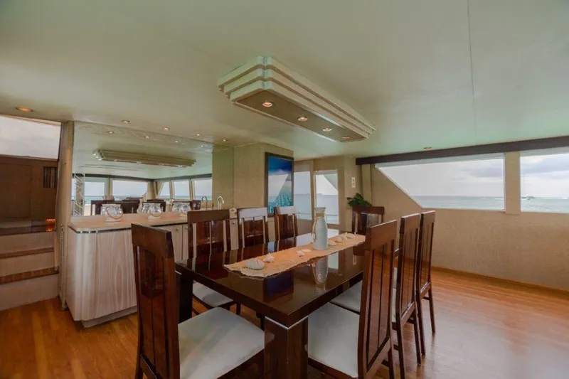 Island Time Yacht Photos Pics Luxurious dining area on a 1991 Broward Motor Yacht with ocean views.
