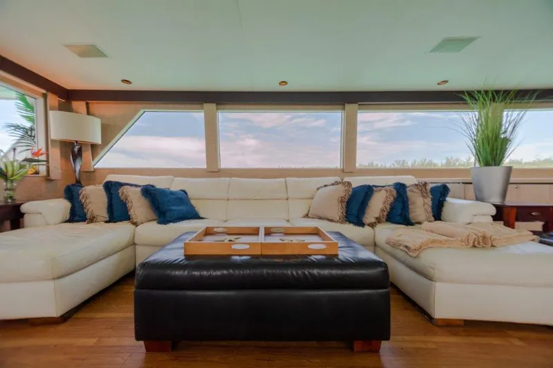 Island Time Yacht Photos Pics Luxurious interior of a 1991 Broward Motor Yacht with plush seating and panoramic windows.