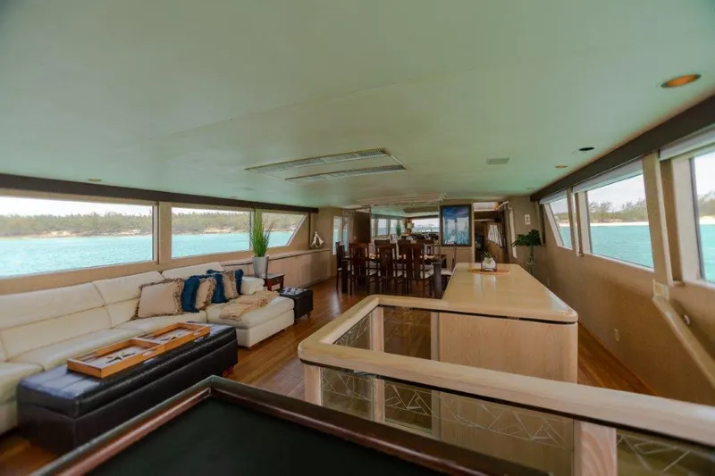 Island Time Yacht Photos Pics Luxurious interior of a 1991 Broward Motor Yacht with panoramic windows and elegant furnishings.