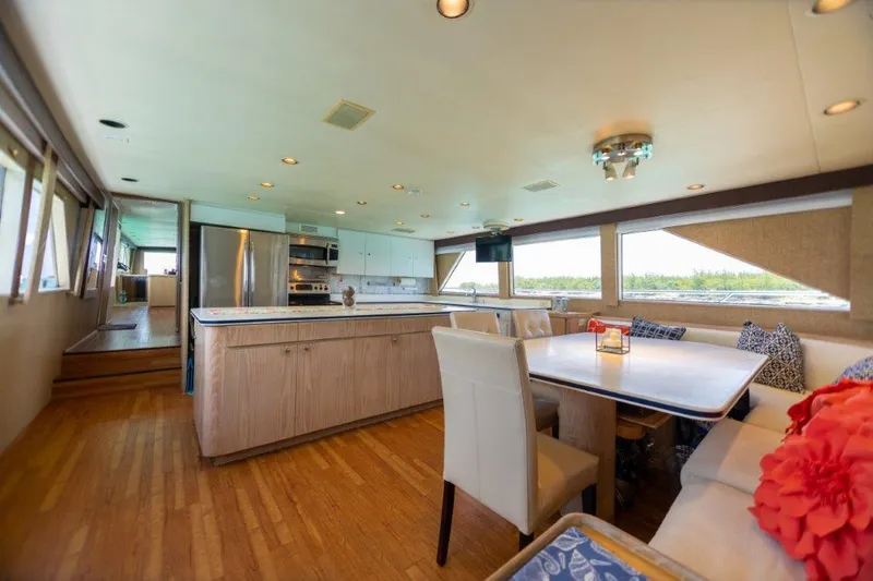 Island Time Yacht Photos Pics Spacious interior of 1991 Broward Motor Yacht with modern kitchen and dining area.