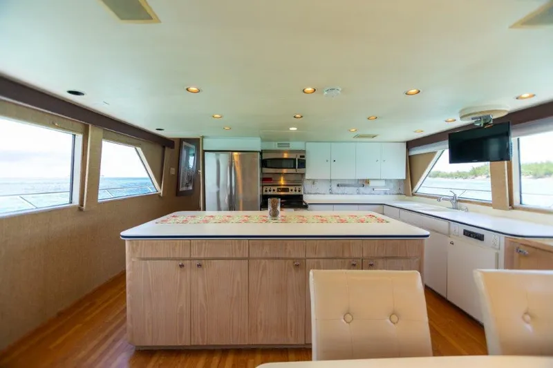 Island Time Yacht Photos Pics Spacious kitchen on a 1991 Broward Motor Yacht with modern appliances and large windows.