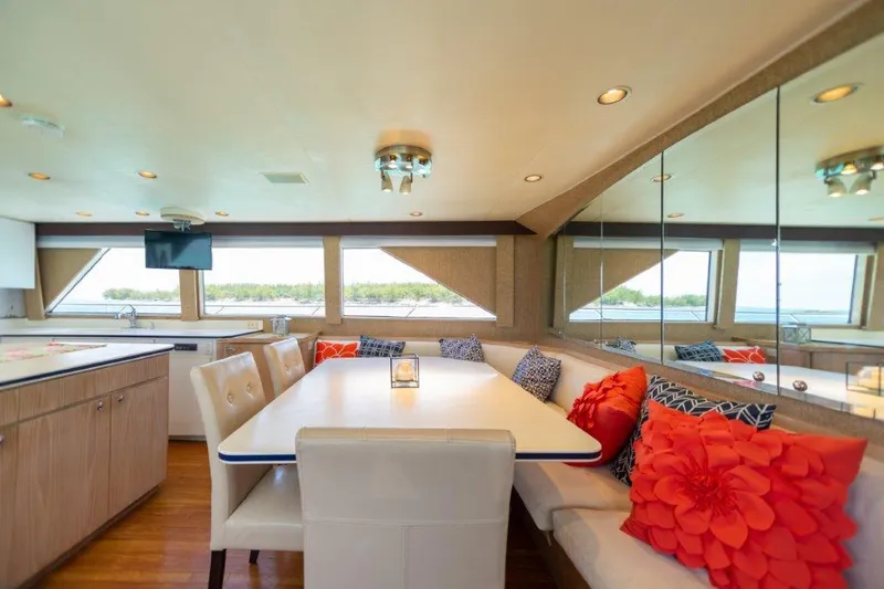 Island Time Yacht Photos Pics Luxurious dining area on a 1991 Broward Motor Yacht with scenic window views.