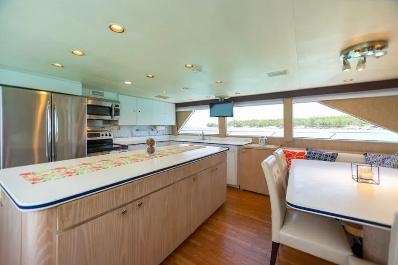 Island Time Yacht Photos Pics Spacious kitchen and dining area inside a 1991 Broward Motor Yacht.