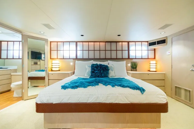 Island Time Yacht Photos Pics Luxurious bedroom in a 1991 Broward Motor Yacht with modern decor.