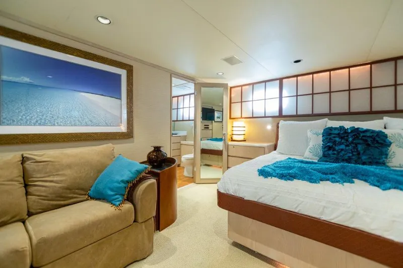 Island Time Yacht Photos Pics Luxurious bedroom interior of a 1991 Broward Motor Yacht with modern decor.