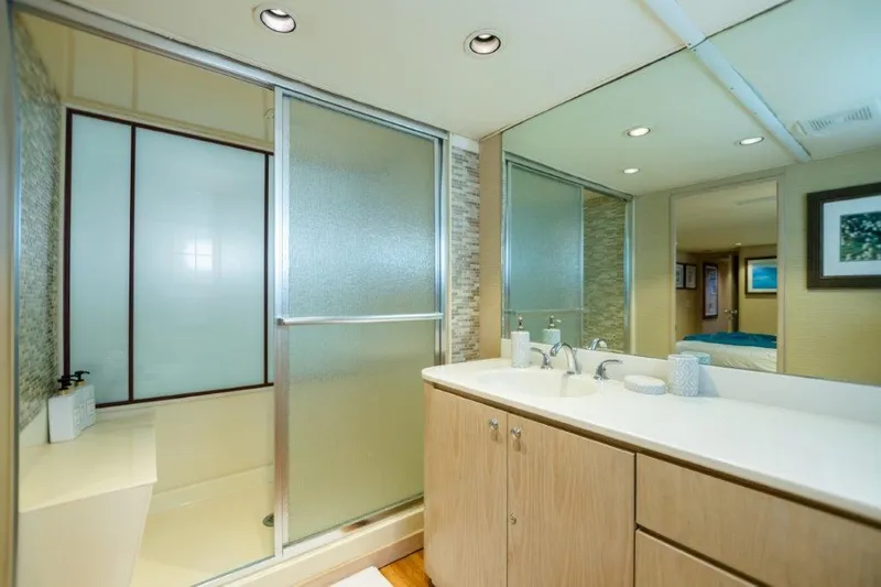 Island Time Yacht Photos Pics Modern bathroom in 1991 Broward Motor Yacht with frosted glass shower and large mirror.