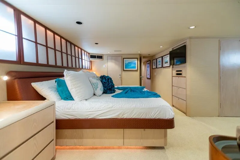 Island Time Yacht Photos Pics Luxurious bedroom interior of 1991 Broward Motor Yacht with modern decor and ample storage.