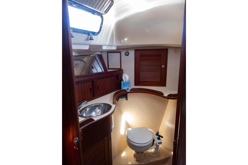 Blue Skies Yacht Photos Pics Interior of 1995 Island Packet 40 sailboat bathroom with sink and toilet.
