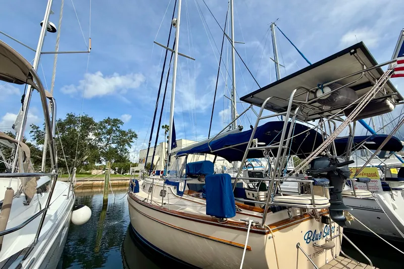 Blue Skies Yacht Photos Pics 1995 Island Packet 40 sailboat docked at marina under blue sky.