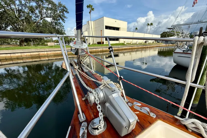 Blue Skies Yacht Photos Pics Bow of 1995 Island Packet 40 sailboat docked in a calm marina.