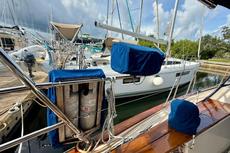 Blue Skies Yacht Photos Pics 1995 Island Packet 40 sailboat docked, featuring covered equipment and propane tanks.