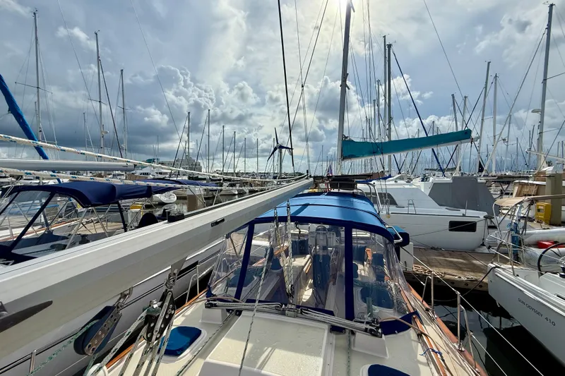 Blue Skies Yacht Photos Pics Sailboats docked at a marina, featuring a 1995 Island Packet 40 under a cloudy sky.