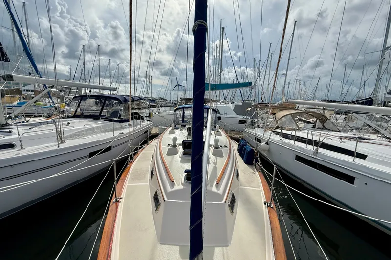 Blue Skies Yacht Photos Pics 1995 Island Packet 40 sailboat docked among other yachts under cloudy skies.