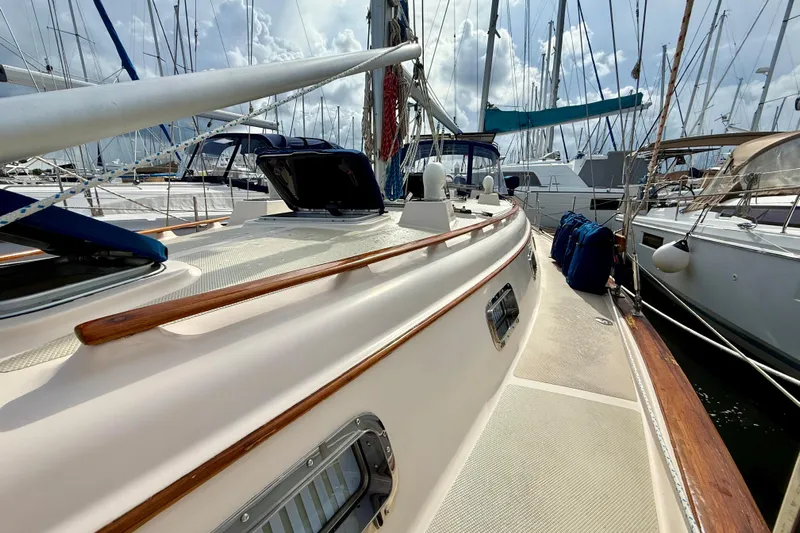 Blue Skies Yacht Photos Pics 1995 Island Packet 40 sailboat docked in marina, showcasing deck and rigging.
