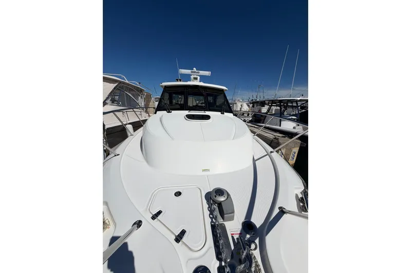  Yacht Photos Pics 2023 Boston Whaler 345 Conquest boat docked at marina under clear blue sky.